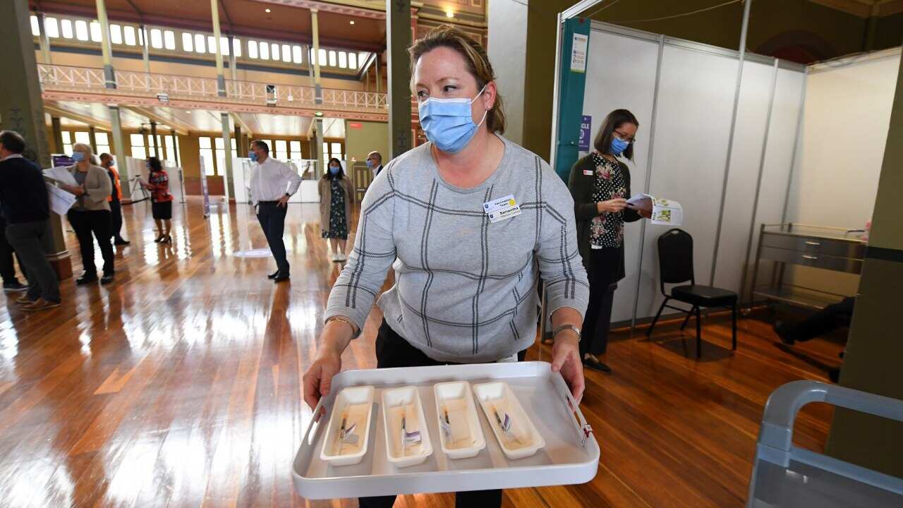 A healthcare worker is seen transporting COVID-19 vaccinations to injecting rooms in Melbourne