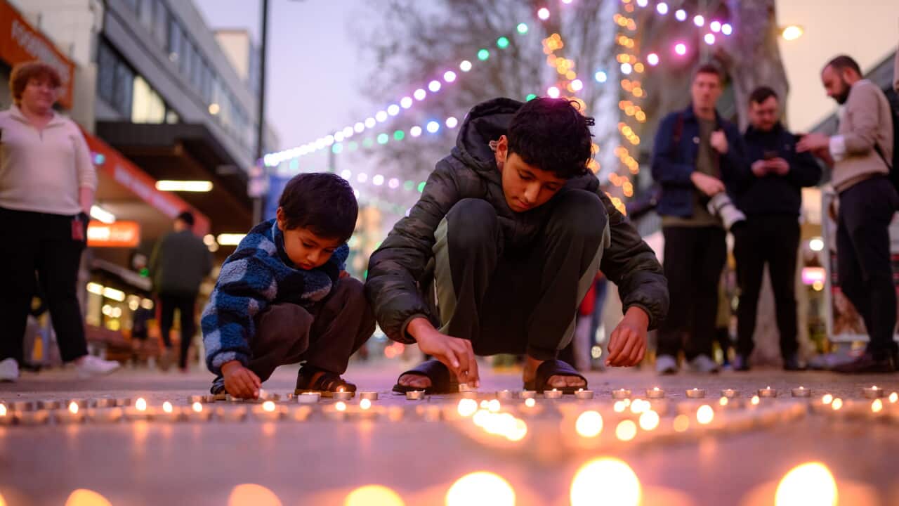 Arvin Poudel, 2.5, and Aayam Poudel, 12, place candles onto the floor during the candle light vigil. Community stands together for thoughts and prayers for those affected by the disaster in Nepal in Rockdale, Sydney, Thursday, August 27, 2026.