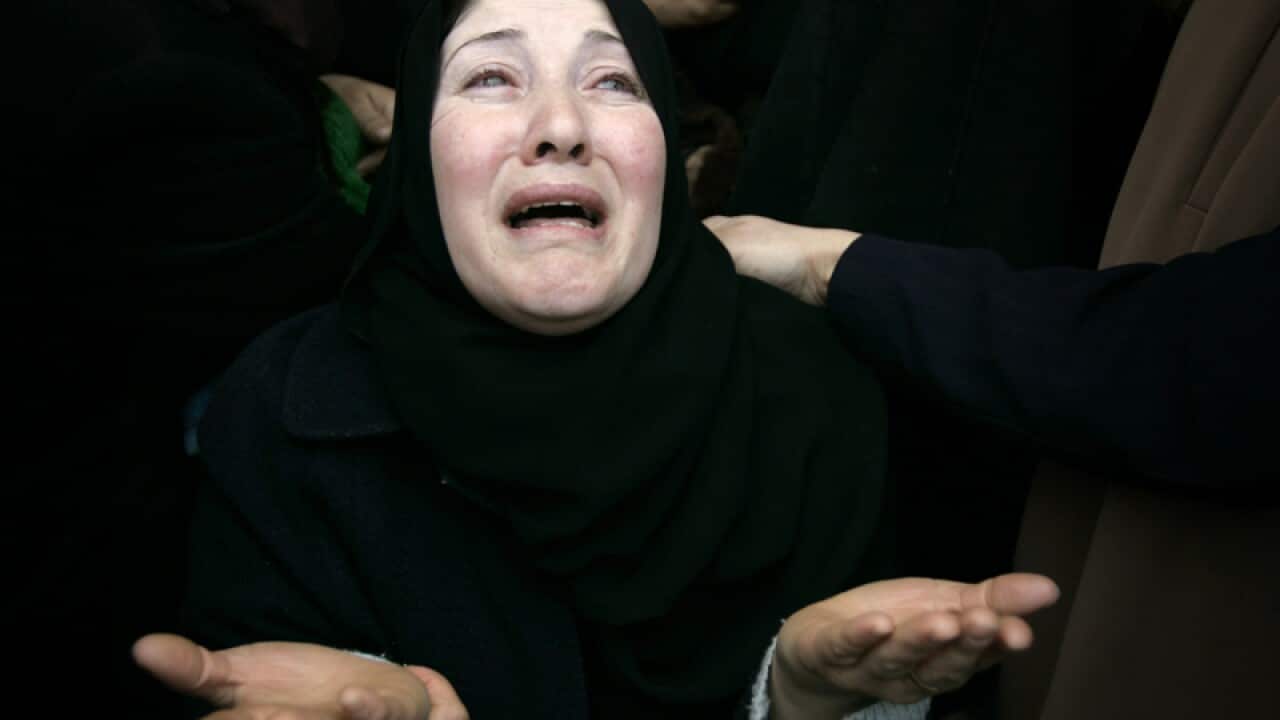 A woman mourns during the funeral for four Palestinian militants