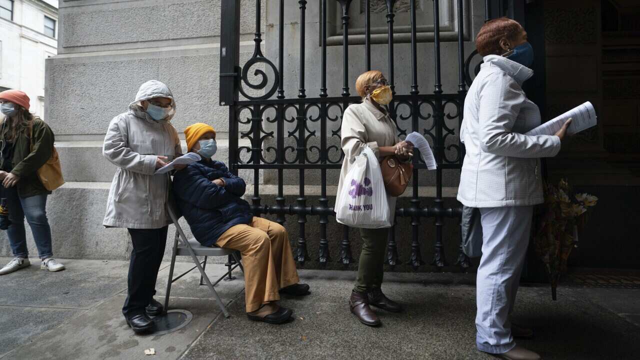Americans wait in line to vote at City Hall in Philadelphia on Monday.