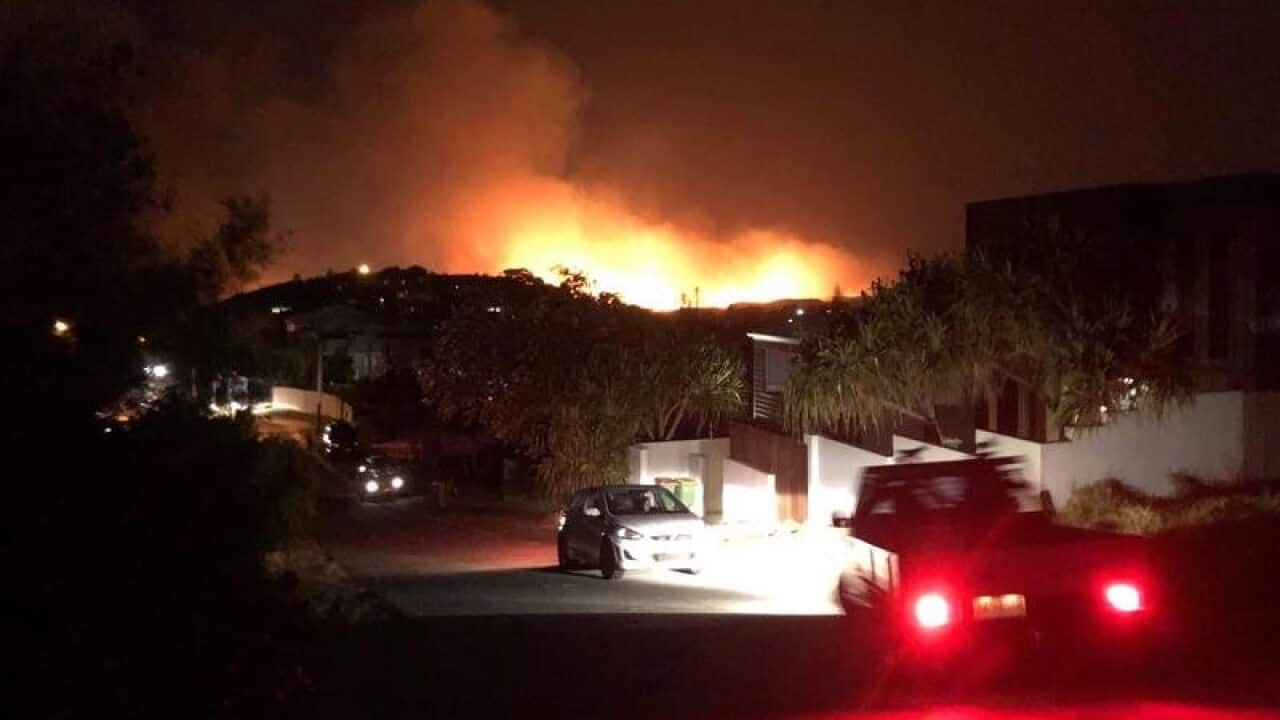 A fire rages in bushland over Peregian Springs in Queensland.