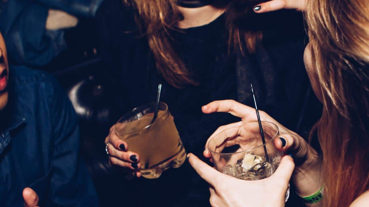 two girls with drinks in their hand