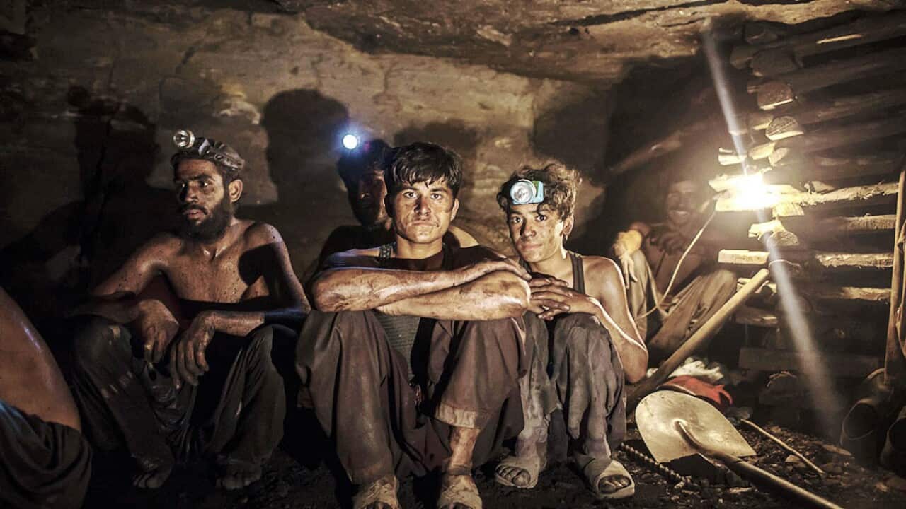 Miners pose for a photograph