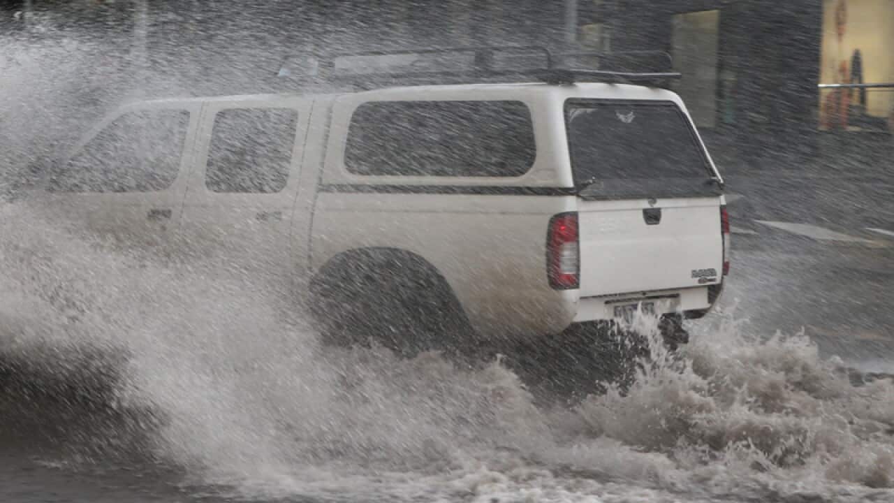 A car drives through flood water