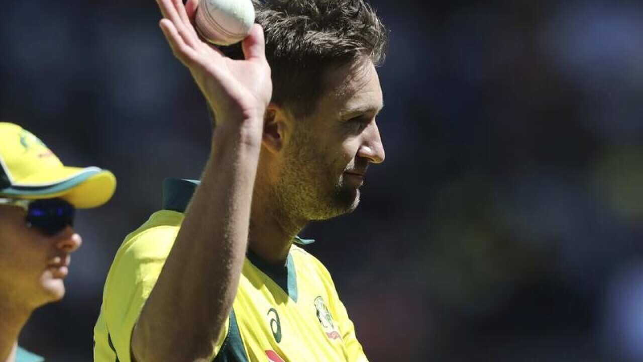 Australia's Andrew Tye holds up a ball.