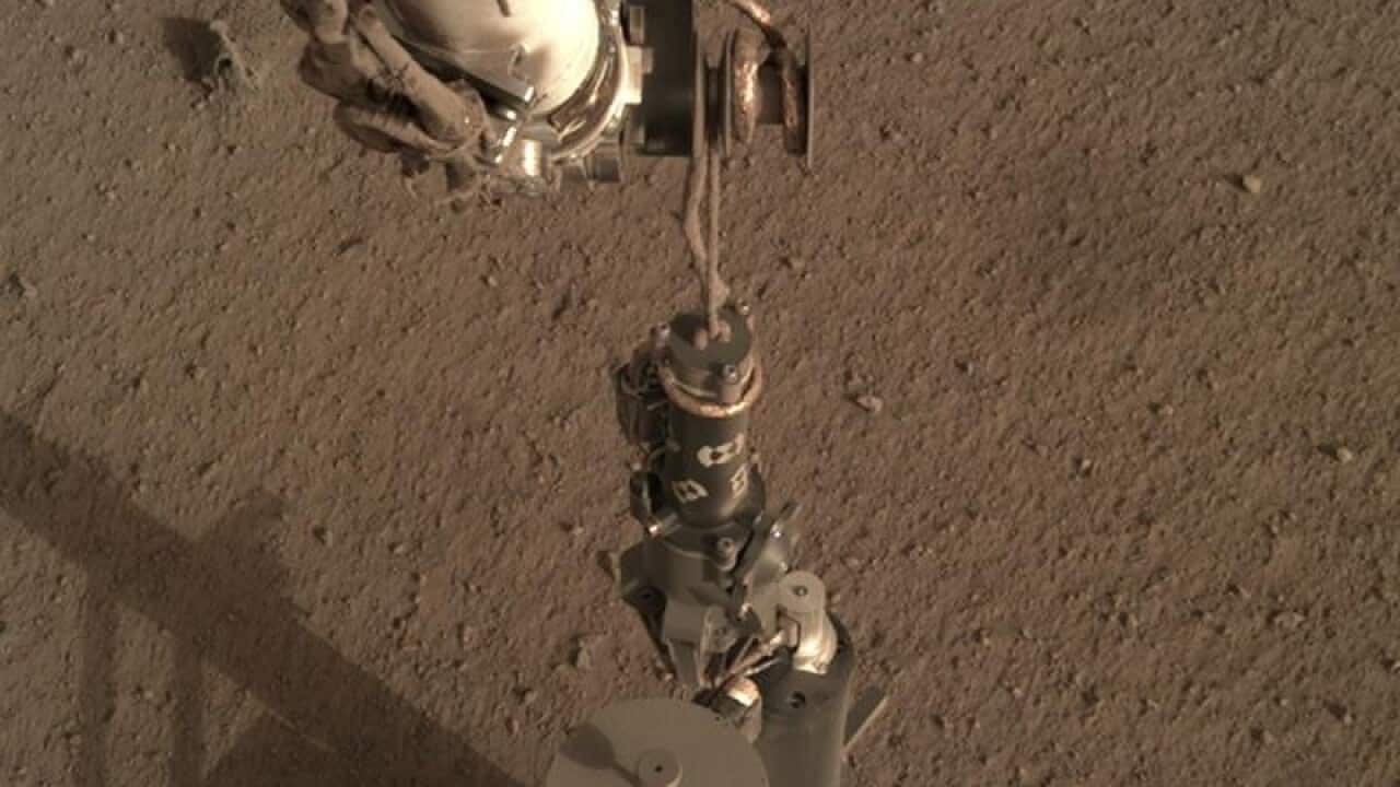 NASA's InSight Mars lander using its robotic arm