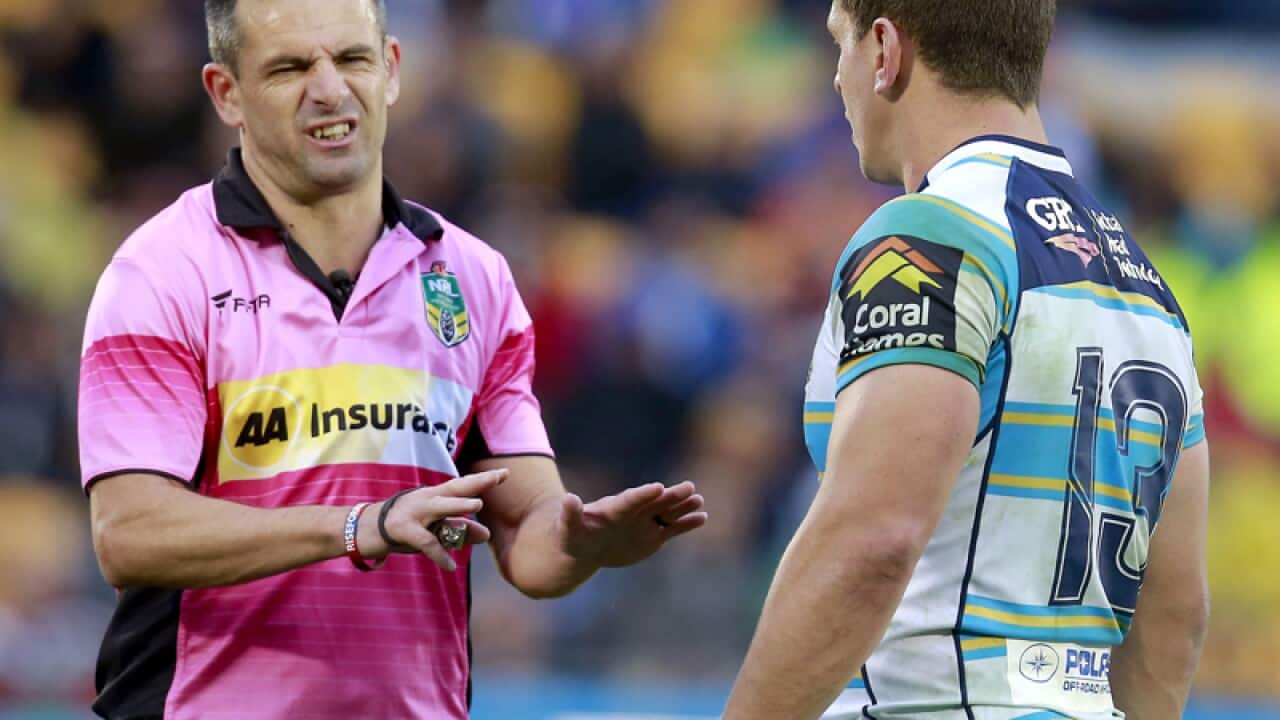 A referee speaks to Titans player Greg Bird