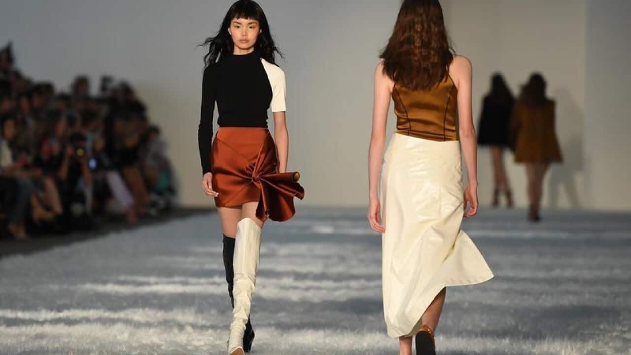 A model walks the runway wearing creations by Bec + Bridge .