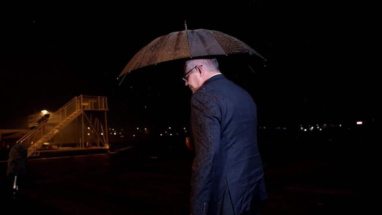 Scott Morrison in the rain after paying tribute to Scott Morrison.