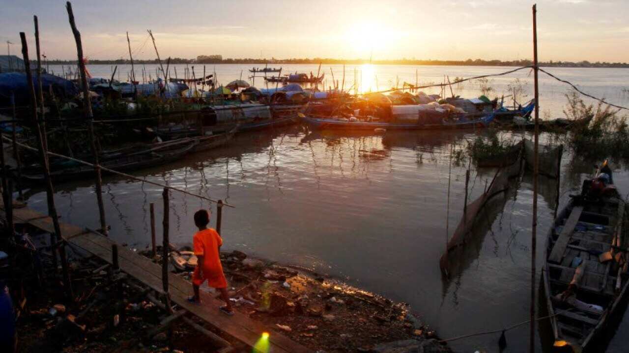 A Cambodian boy walks across a bamboo bridge at the fishing village of Tuol Yey Ma along the Mekong River bank near Phnom Penh, Cambodia (AP Photo/Heng Sinith, File)