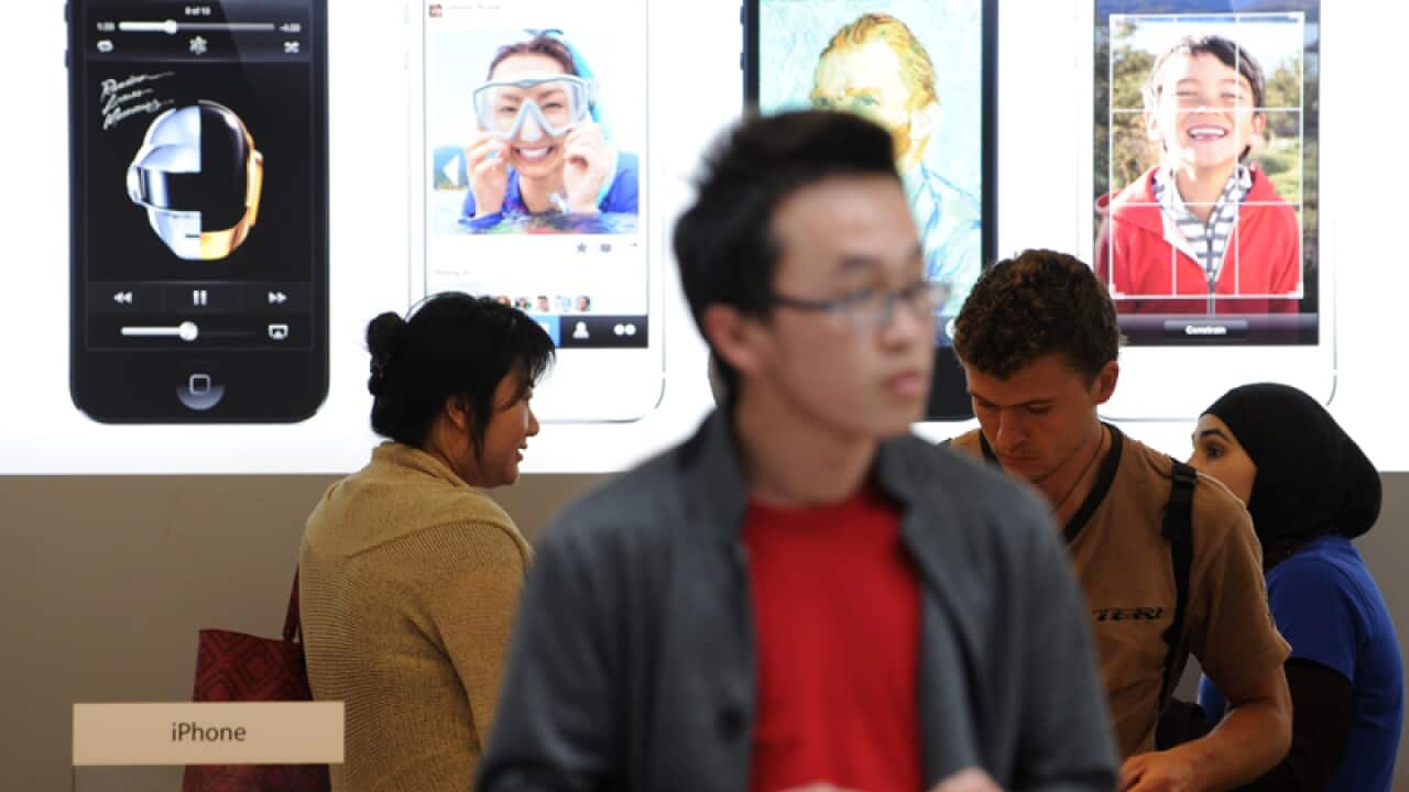 Customers at an Apple store in Sydney