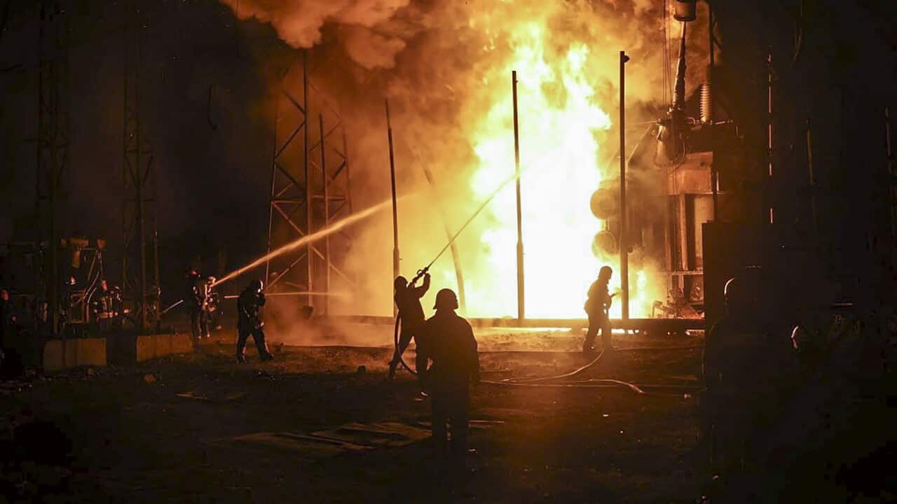 Firefighters put out a blaze after a rocket attack in Kharkiv
