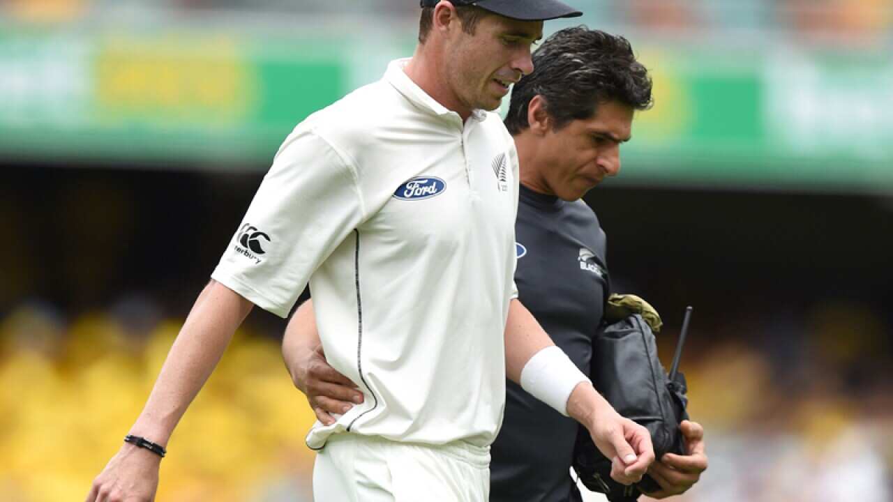 New Zealand pace bowler Tim Southee (left) is assisted from the field