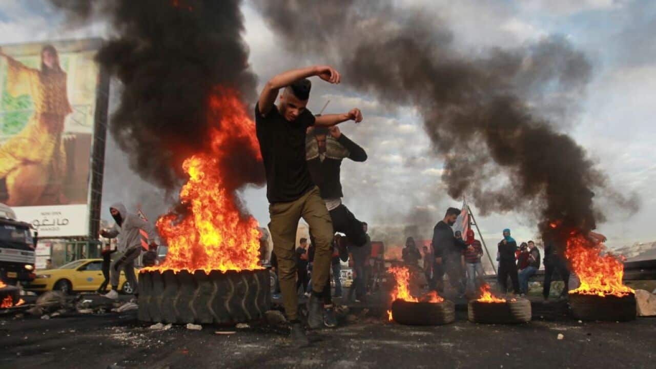 Palestinians burn tires in Nablus response to Israeli security forces' intervention in a demonstration against US President Donald Trump