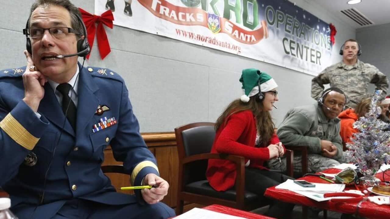 File picture of volunteers at NORAD answering children's calls