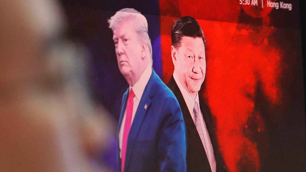 A computer screen shows images of Chinese President Xi Jinping, right, and U.S. President Donald Trump.