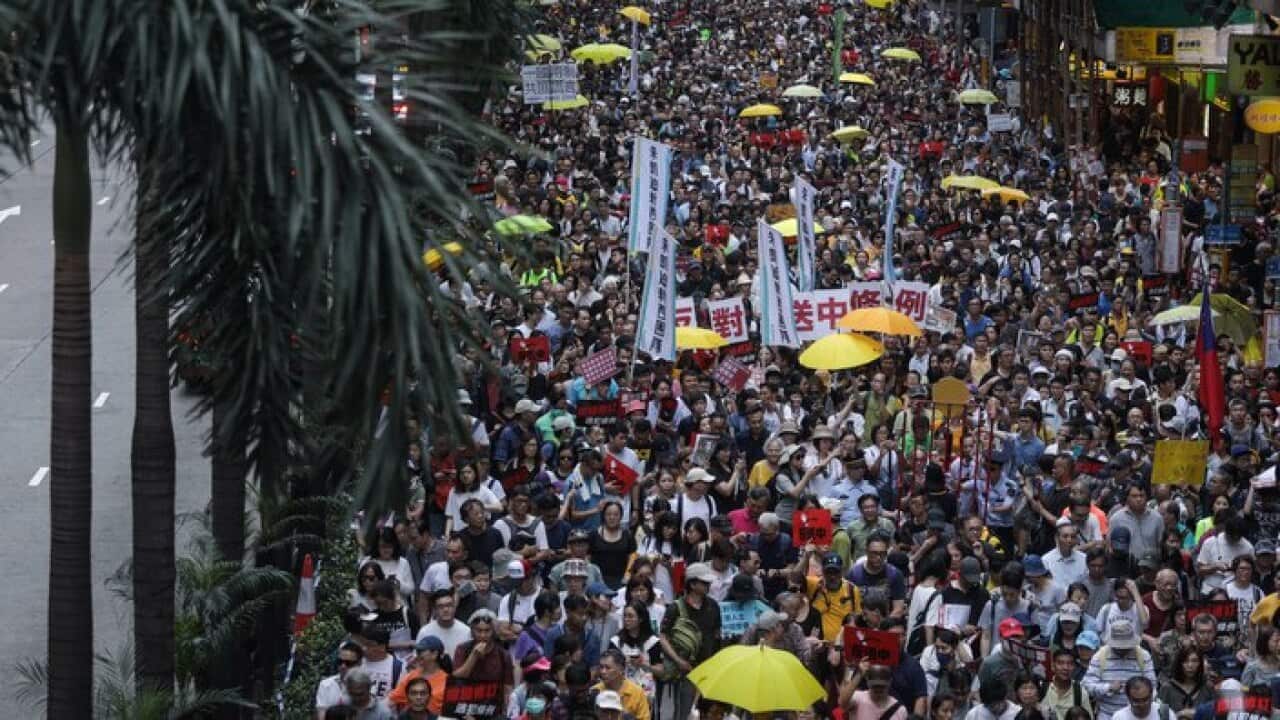Demonstrators seen marching down Hong Kong's main thoroughfare during the protest