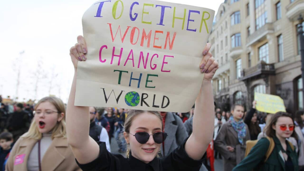 A protester seen holding a placard during the protest.