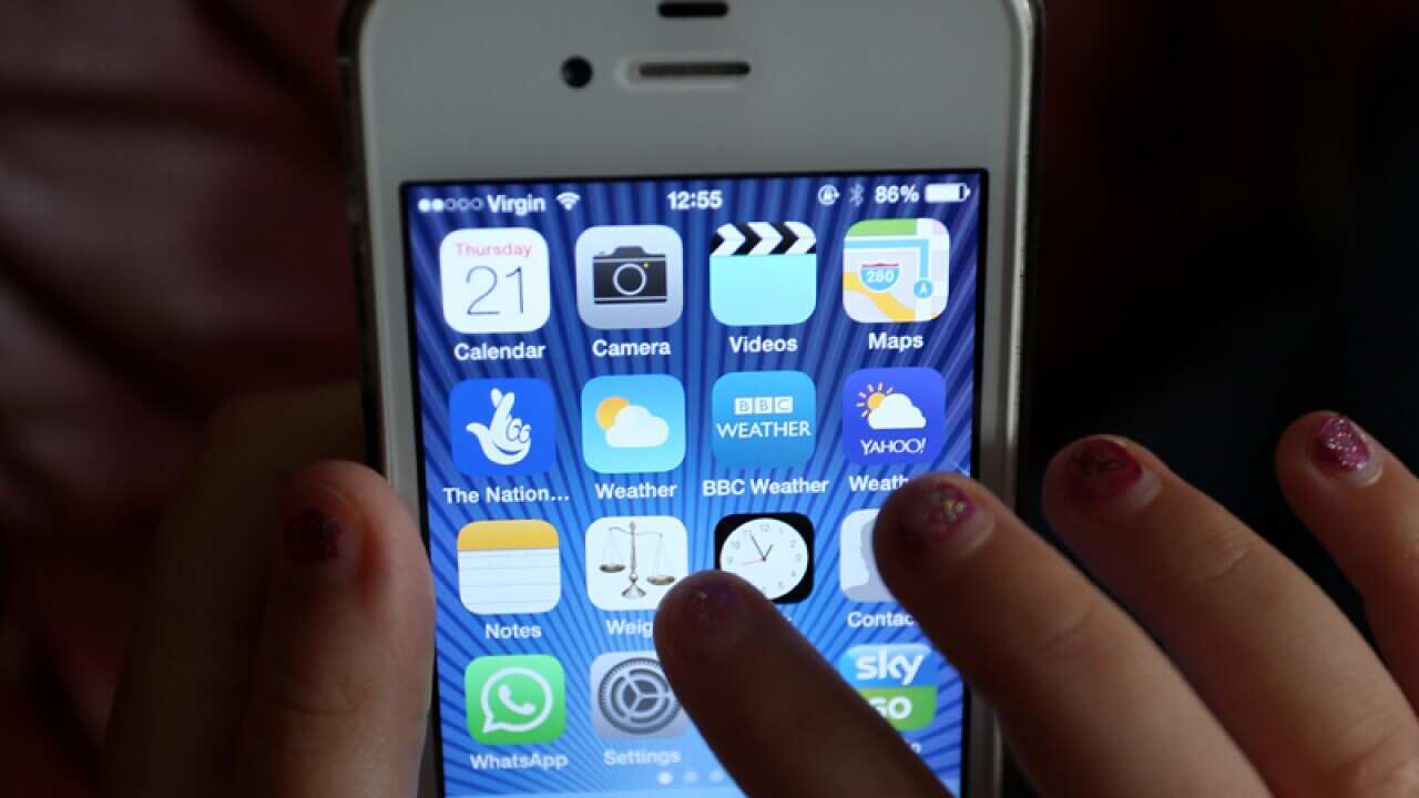 Generic stock photo of a child using an Apple iPhone smartphone