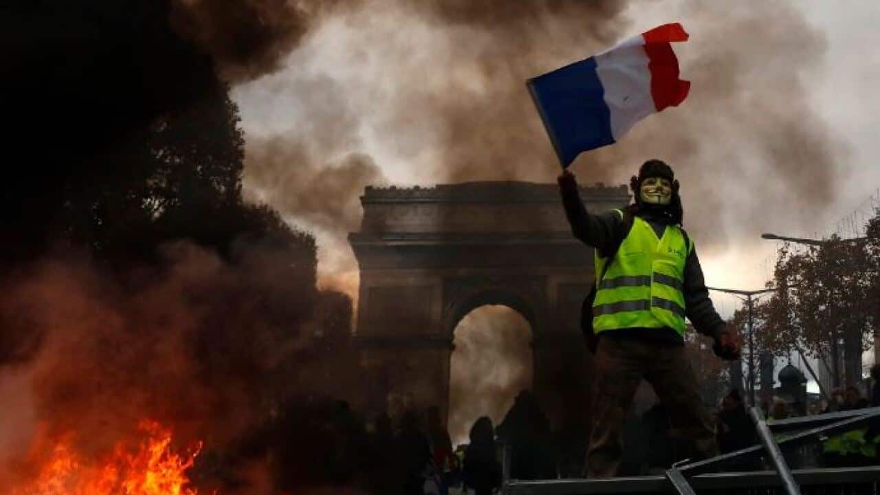Yellow vests (Gilets jaunes) protest against rising oil prices and living costs near the Arc de Triomphe on the Champs Elysees in Paris.