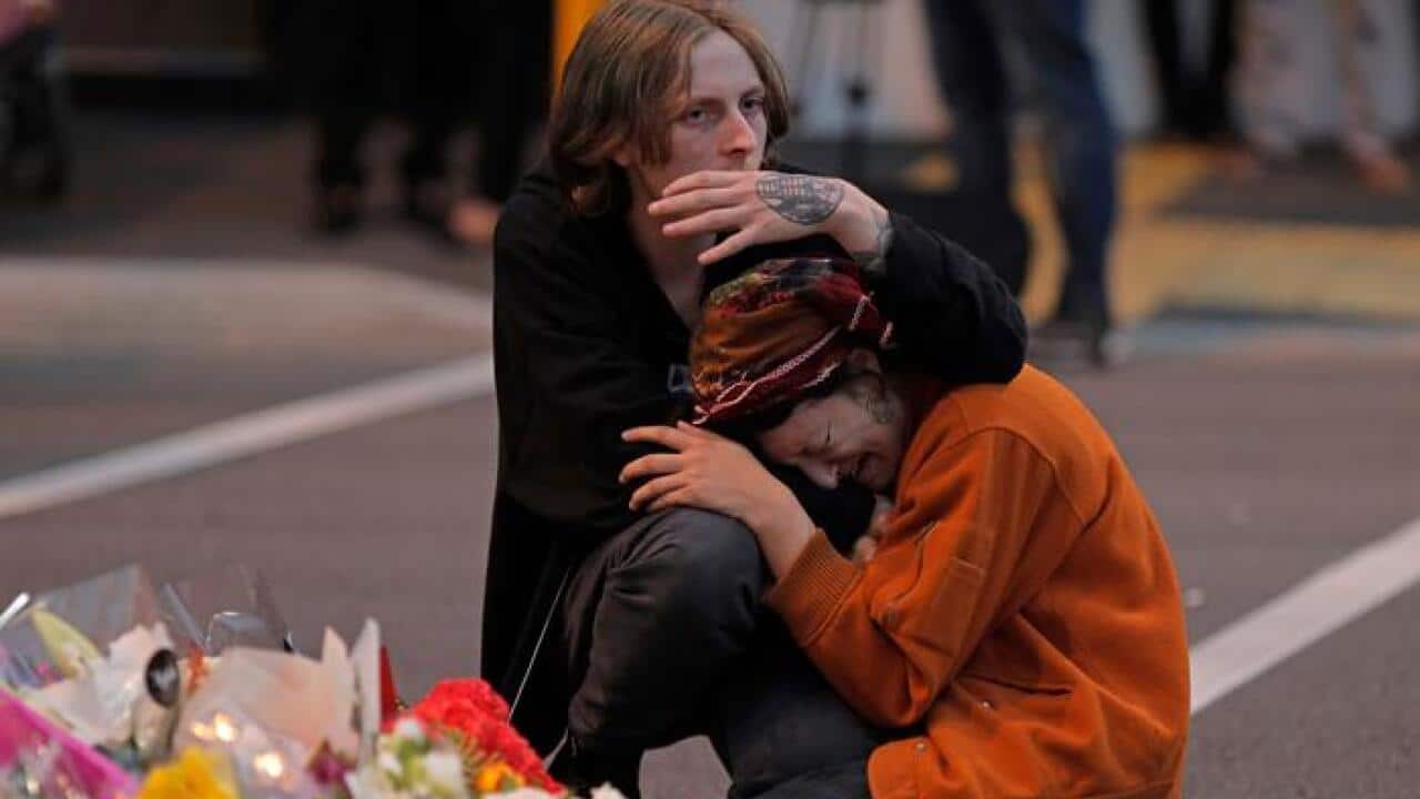 Mourners pay their respects at a makeshift memorial near the Masjid Al Noor mosque