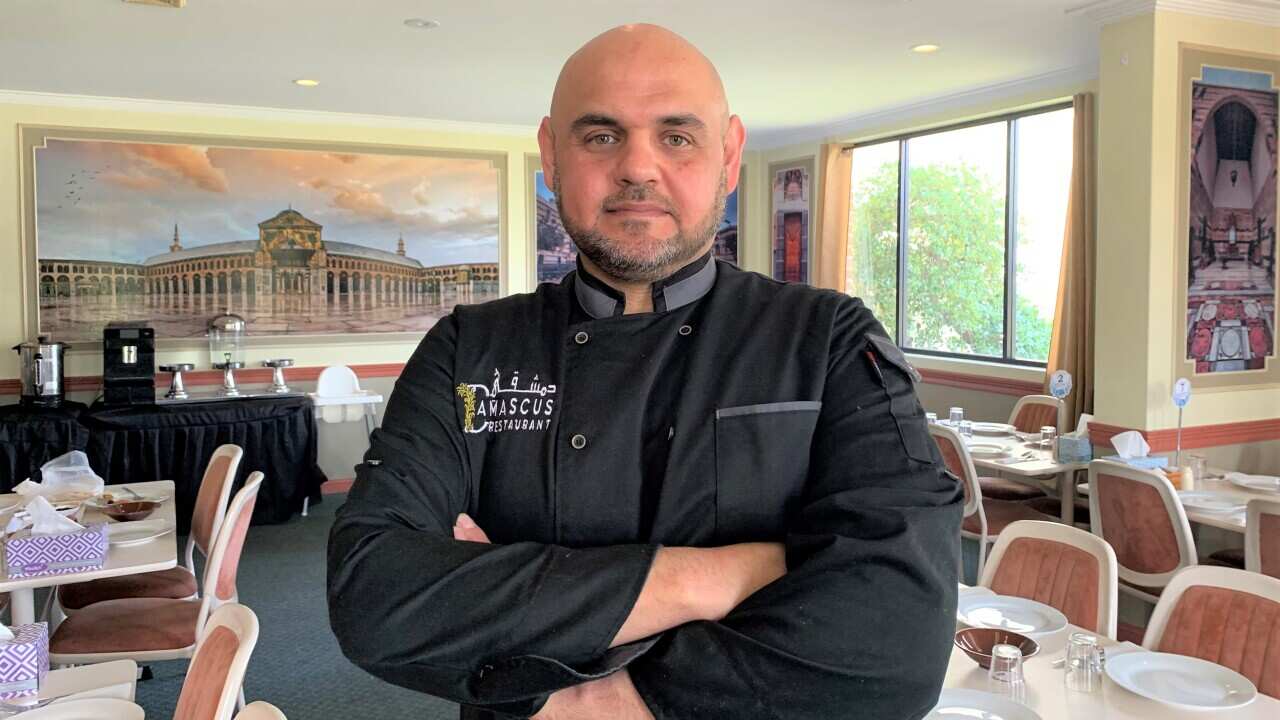 Talal Almardoud standing in an empty restaurant