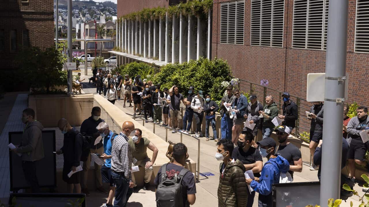 People stand in long lines to receive the monkeypox vaccine at San Francisco General Hospital