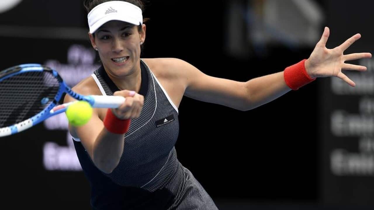 Garbine Muguruza of Spain returns the ball to Kiki Bertens.