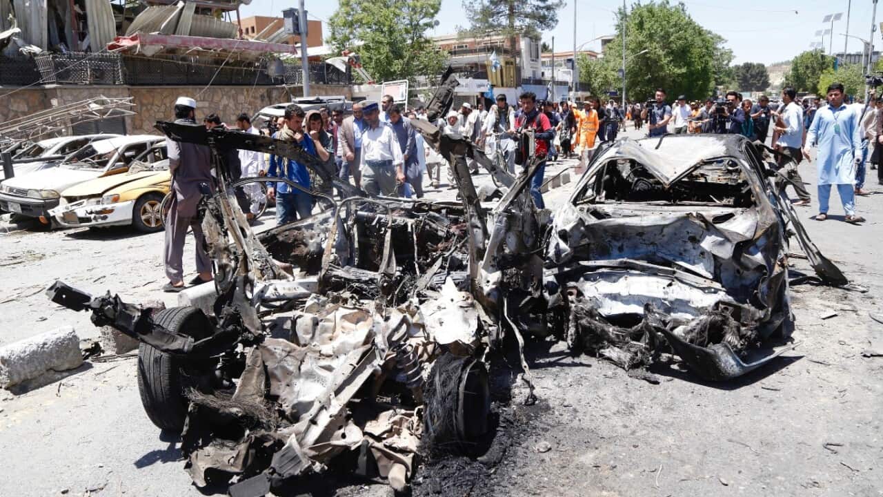 People survey the scene of a suicide bomb attack in Kabul, Afghanistan, 31 May 2017.