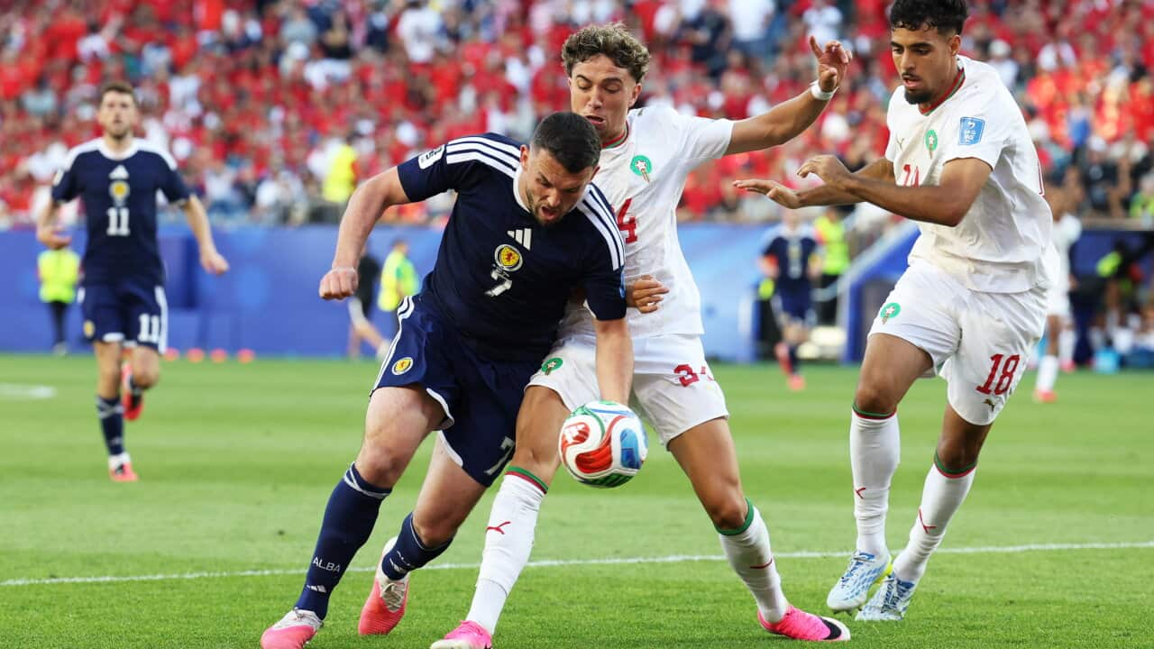A player Morocco and a player for Scotland contest the ball