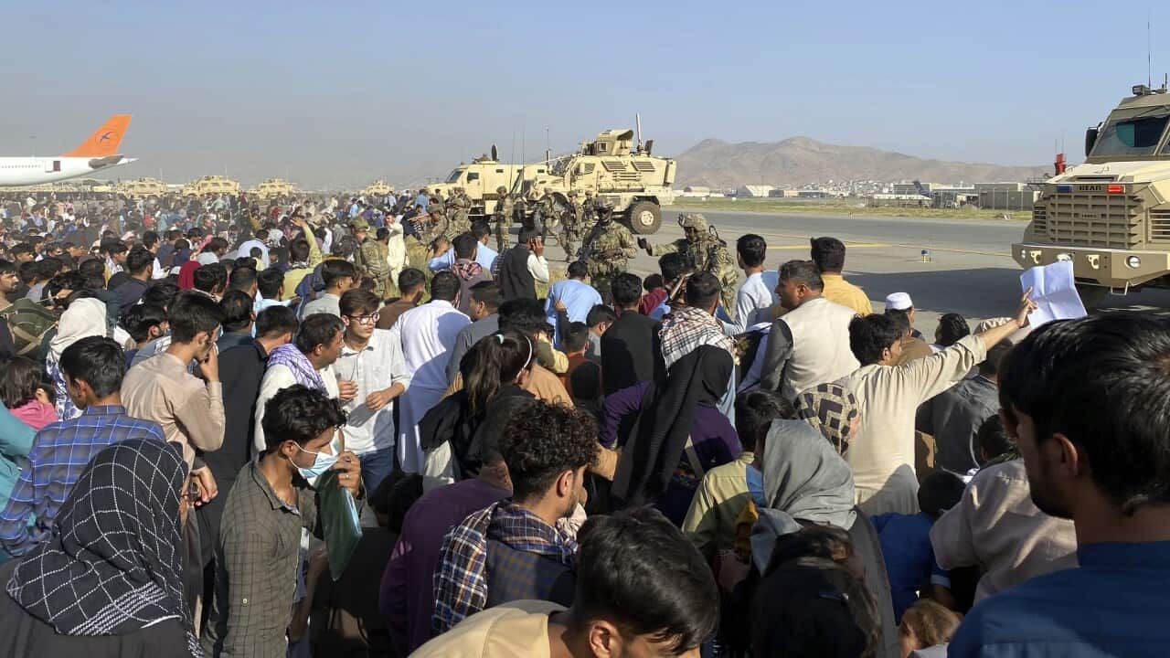 U.S soldiers stand guard along a perimeter at the international airport in Kabul