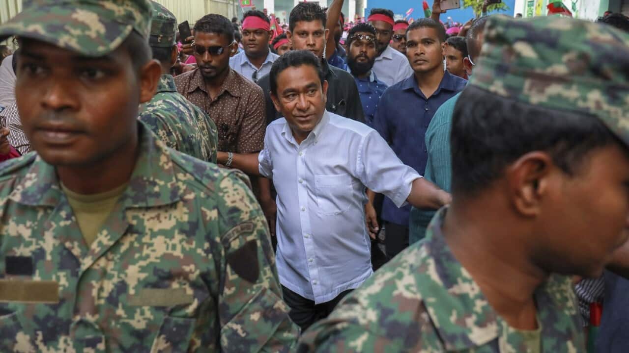Maldivian president Yameen Abdul Gayoom (centre) surrounded by his body guards in Male, Maldives.