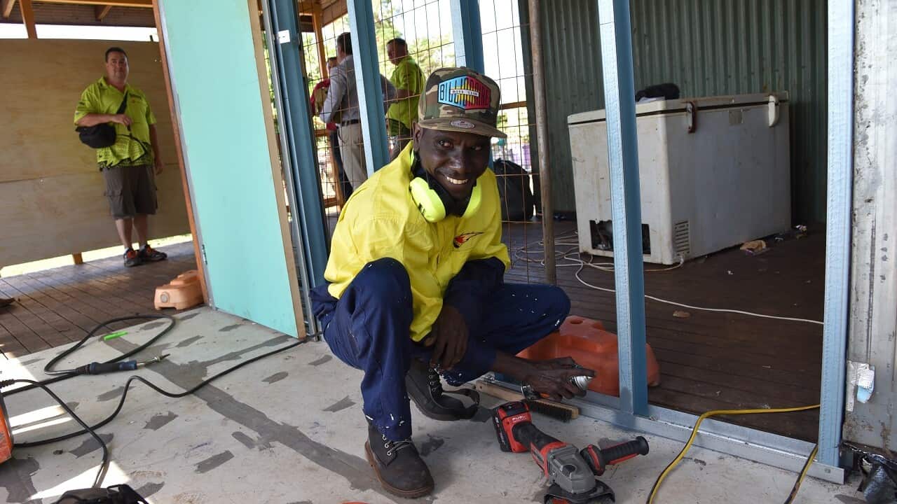 House under construction and worker