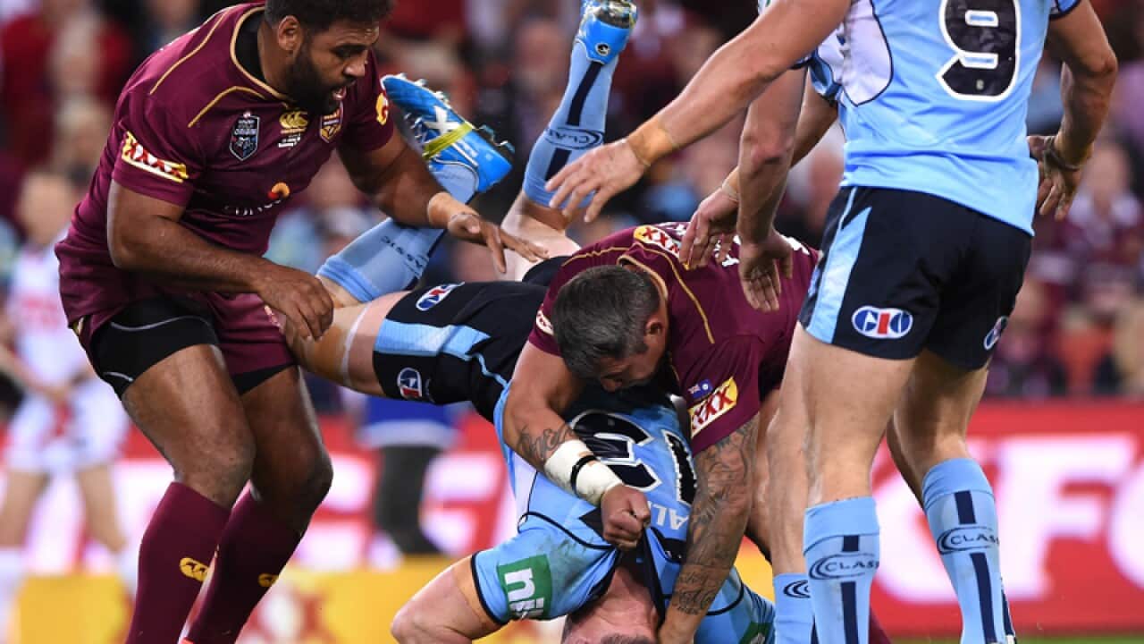 Queensland's Sam Thaiday (L) lifts NSW's Paul Gallen in a tackle