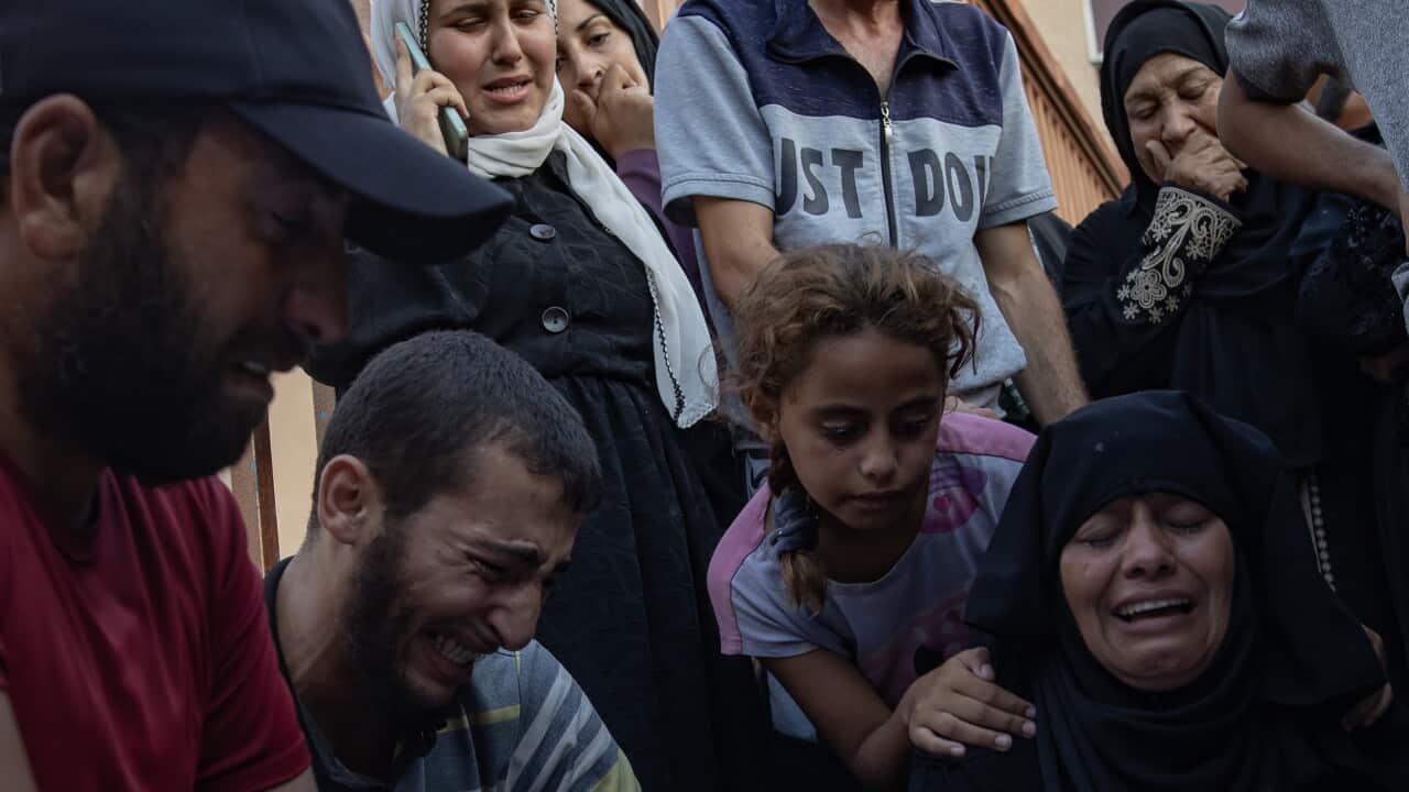 Palestinian families gather next to bodies at Nasser Hospital in Gaza