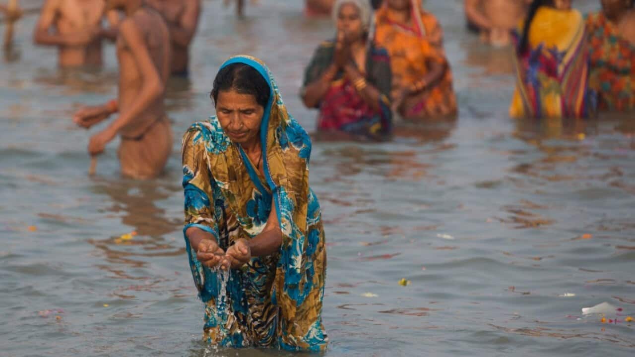 Hindu devotees offer prayers to the Sun God at the river Ganges.