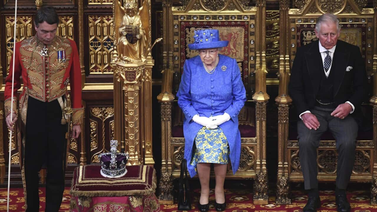Queen Elizabeth II and Prince Charles sit in the House of Lords