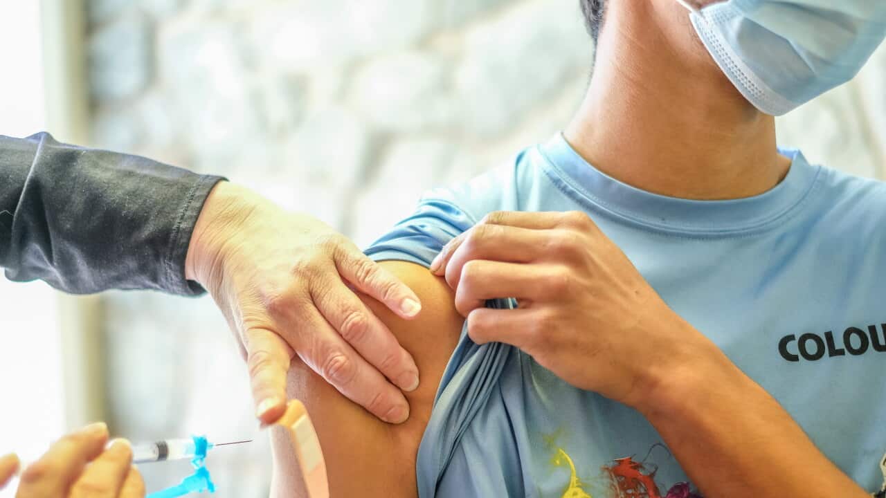 A young man receives his COVID-19 vaccination.