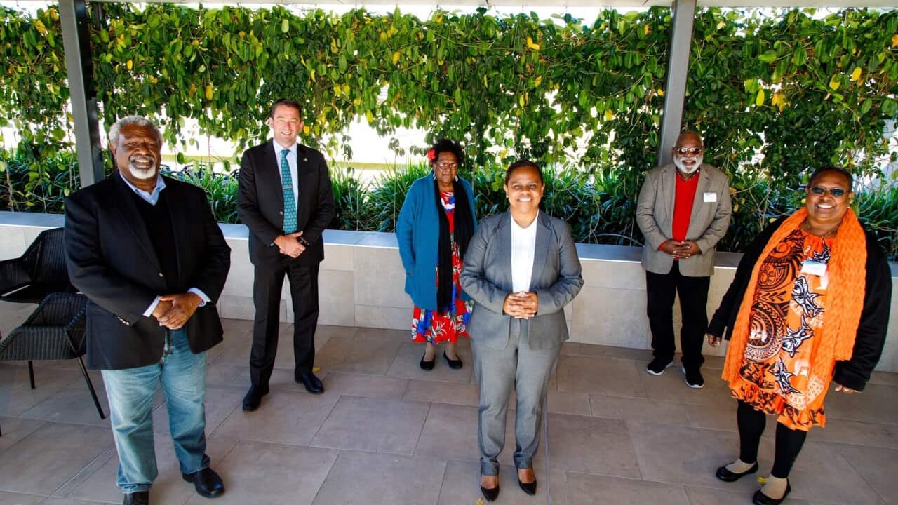 Iamalaig woman, Cynthia Lui (centre), stands with TSI Traditional Owners and Minister for Aboriginal and TSI Partnerships, Craig Crawford.