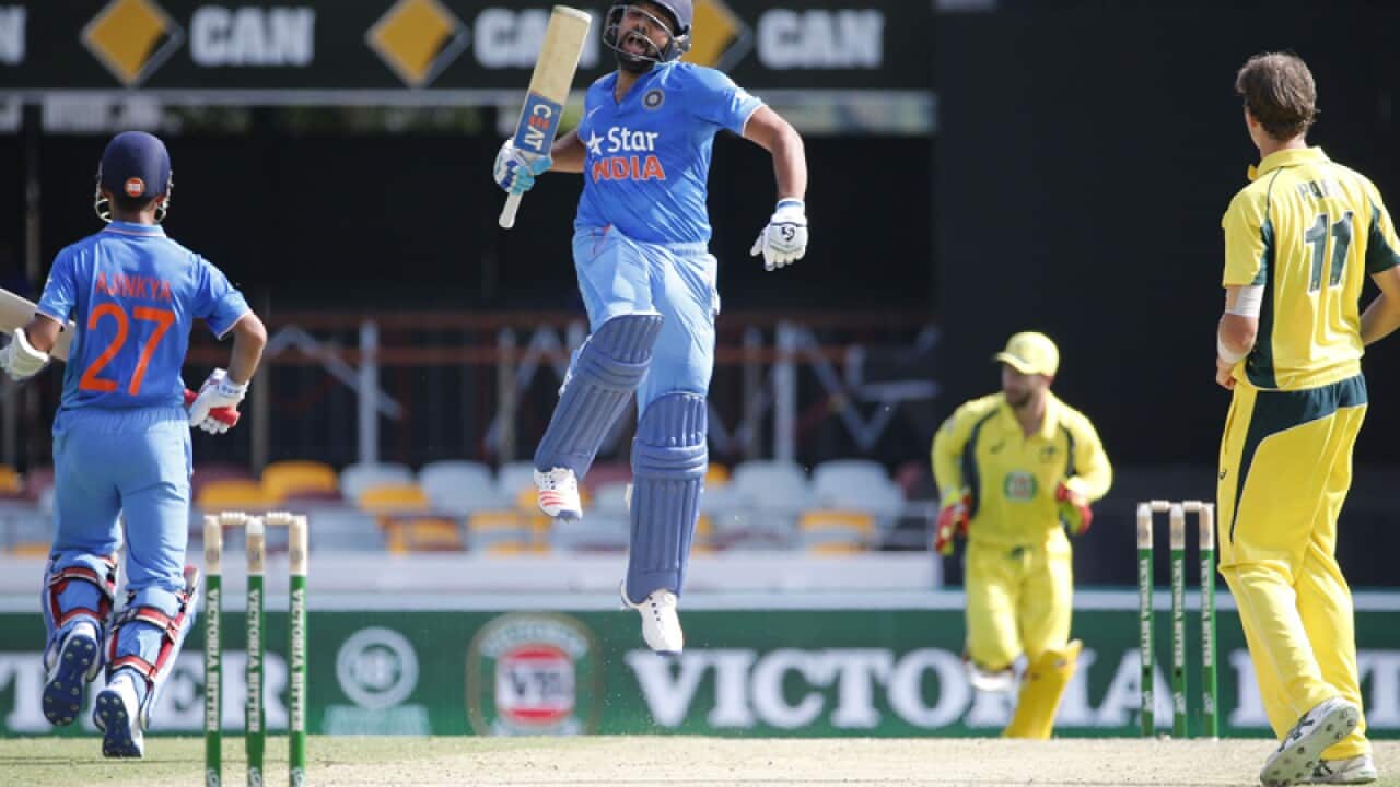 Indian batsman Rohit Sharma (centre) celebrates after scoring 100 runs