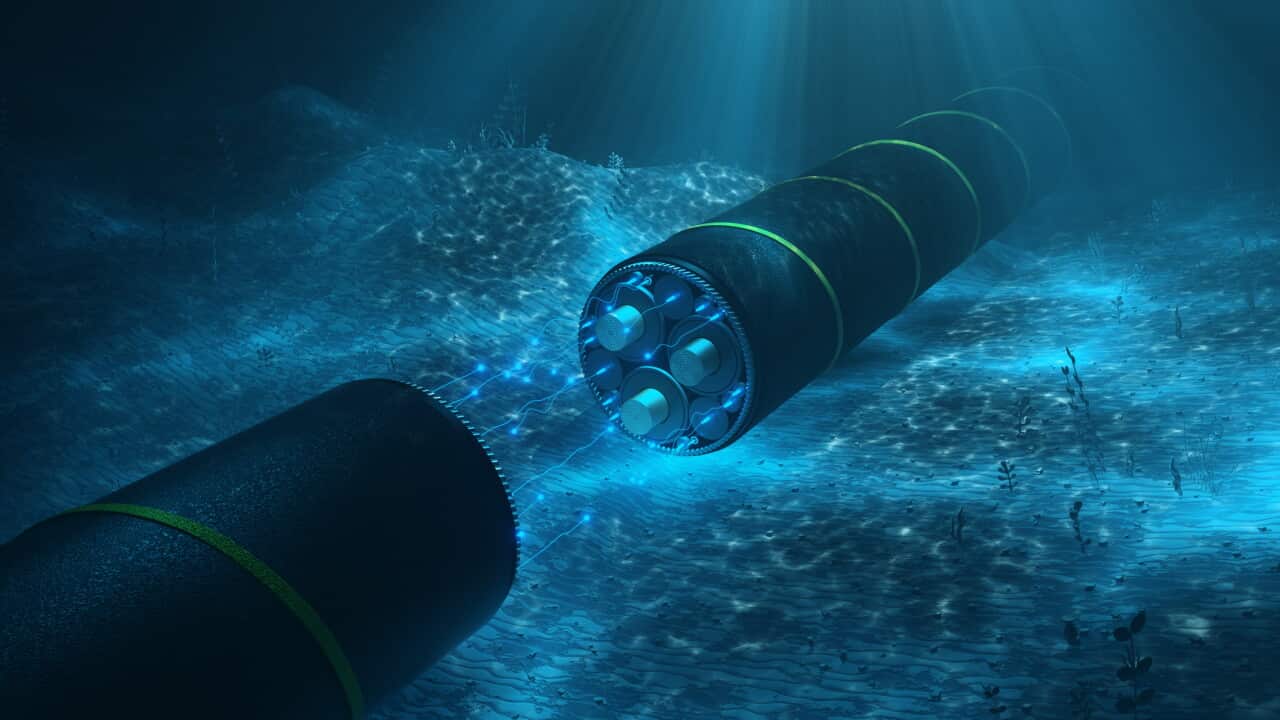 Close-up of a cutaway undersea cable with glowing fiberglass on the seabed. Cable for transmission of electricity and internet under the water of the ocean.