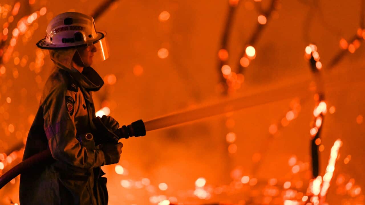 A fireman attends a bushfire in Yanchep, Western Australia