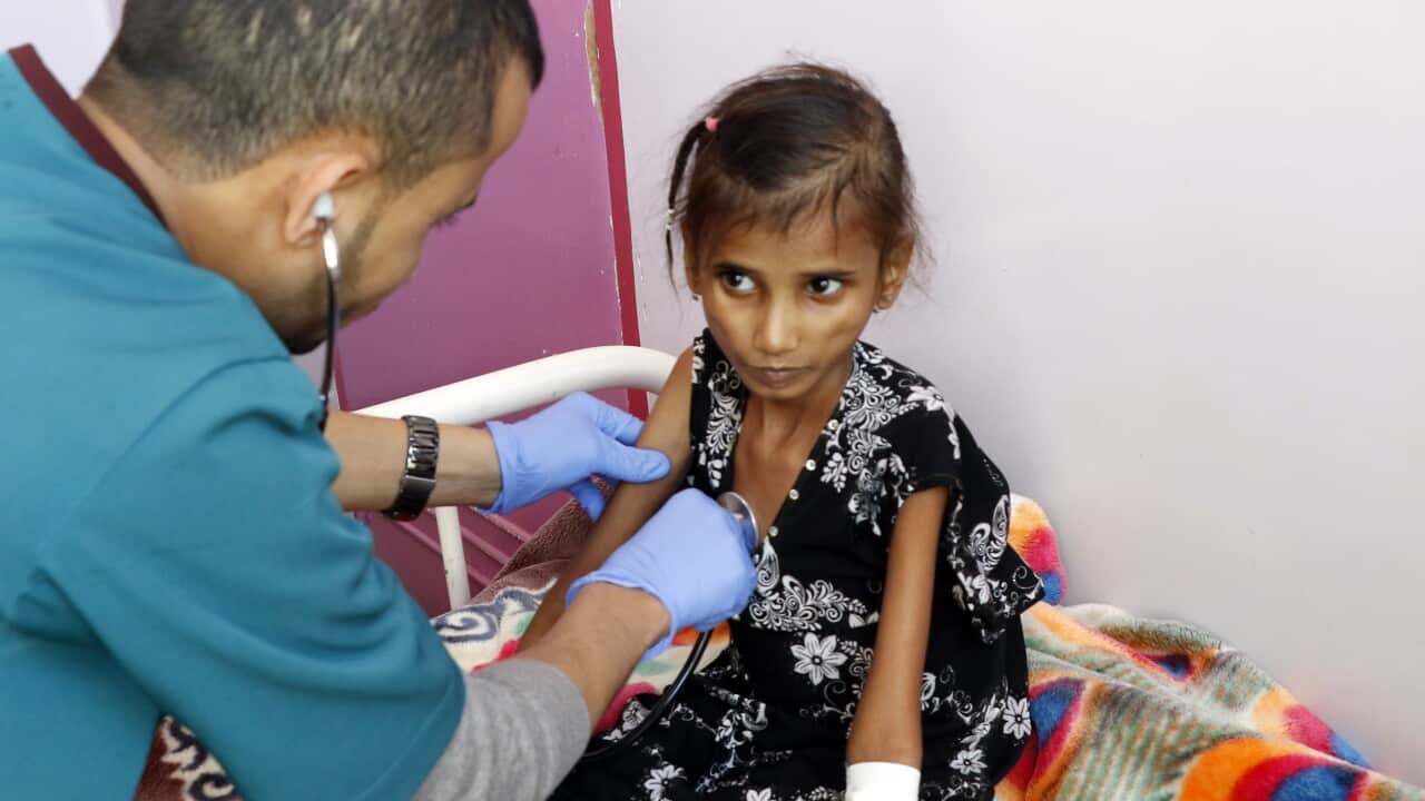 A doctor checks a malnourished girl as she receives treatment at the al-Sabeen hospital on 13 February, 2021, in Sana'a, Yemen.