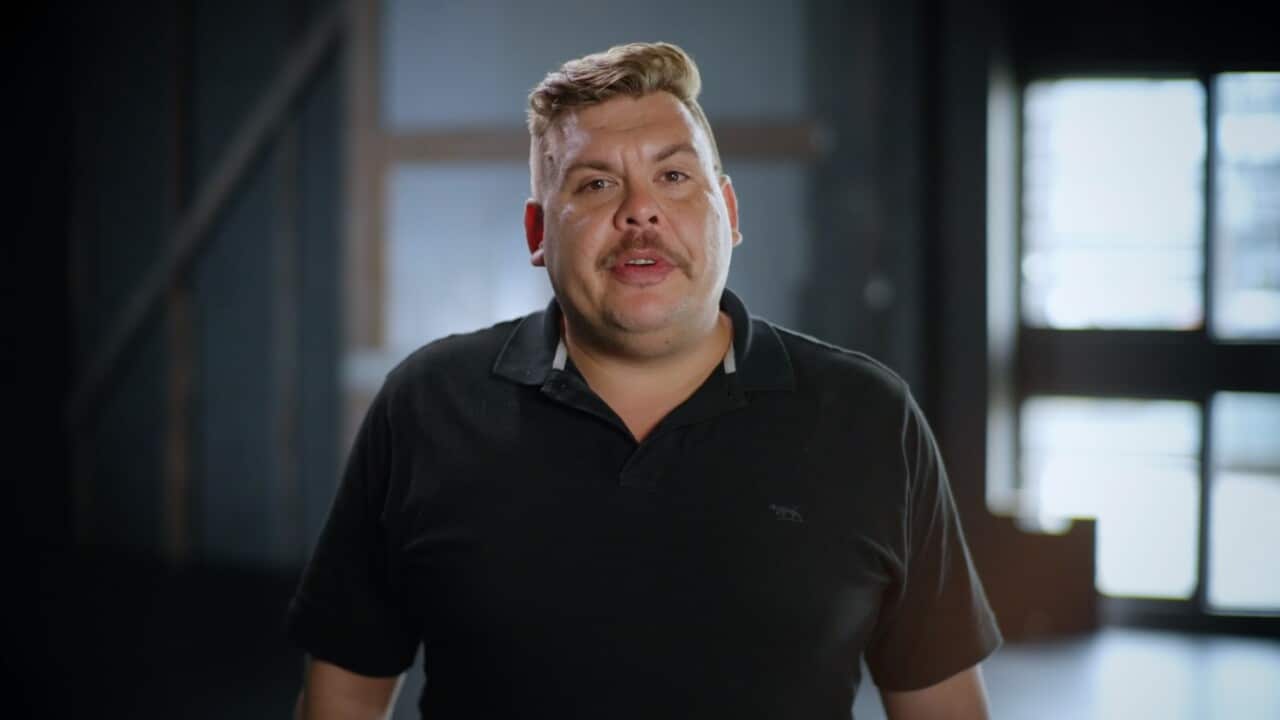 Steven Satour wearing a black T-shirt.