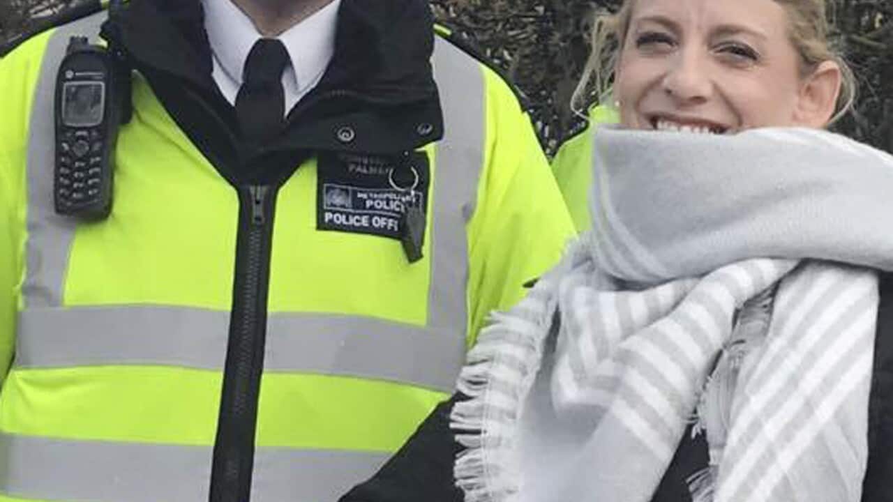 Staci R. Martin is pictured posing for a photo next to Police Officer Keith Palmer outside the Houses of Parliament in London