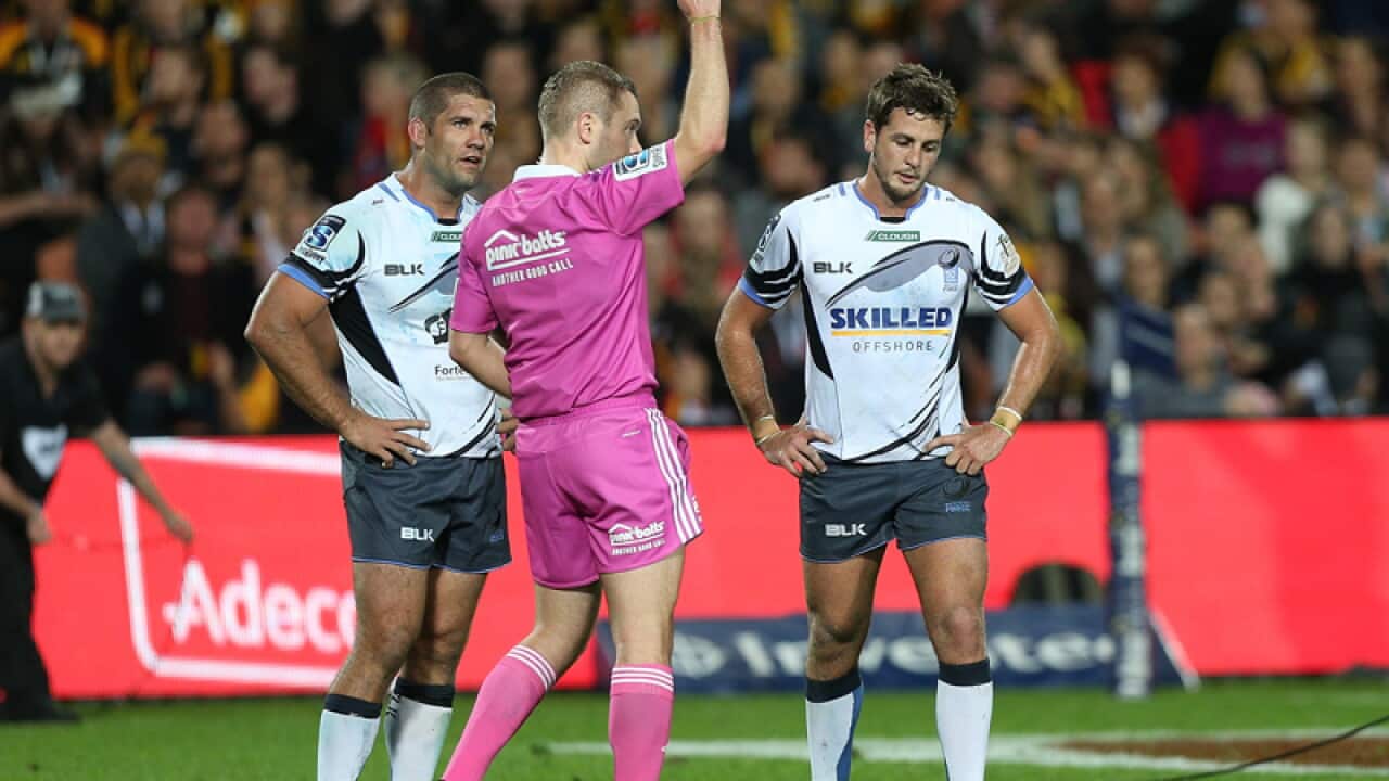 Ian Prior of the Force is shown a red card