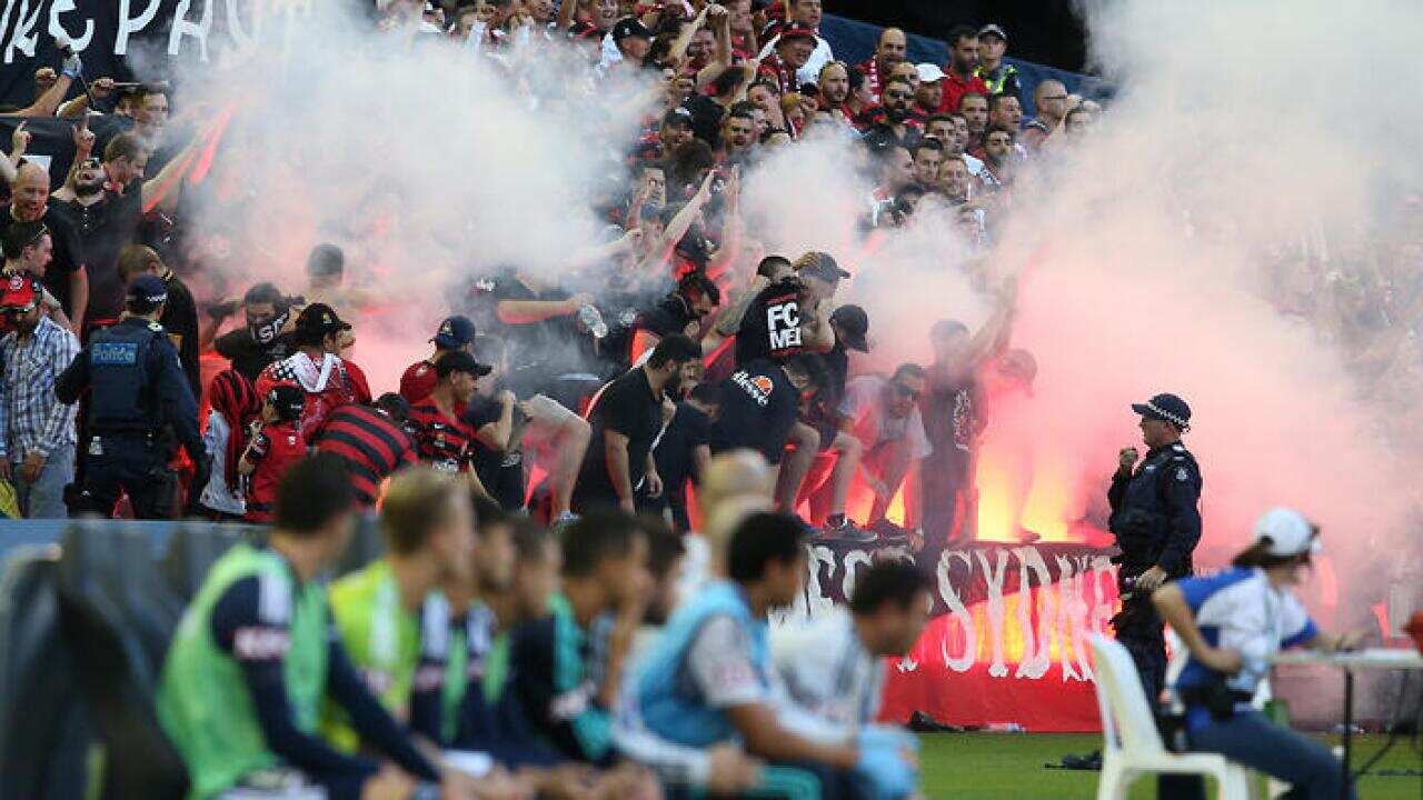 Wanderer fans let off flares during the round 18 A-League match between Melbourne Victory and Western Sydney Wanderers at Etihad Stadium in Melbourne, on Saturday, Feb. 6, 2016. (AAP Image/David Crosling) NO ARCHIVING, EDITORIAL USE ONLY