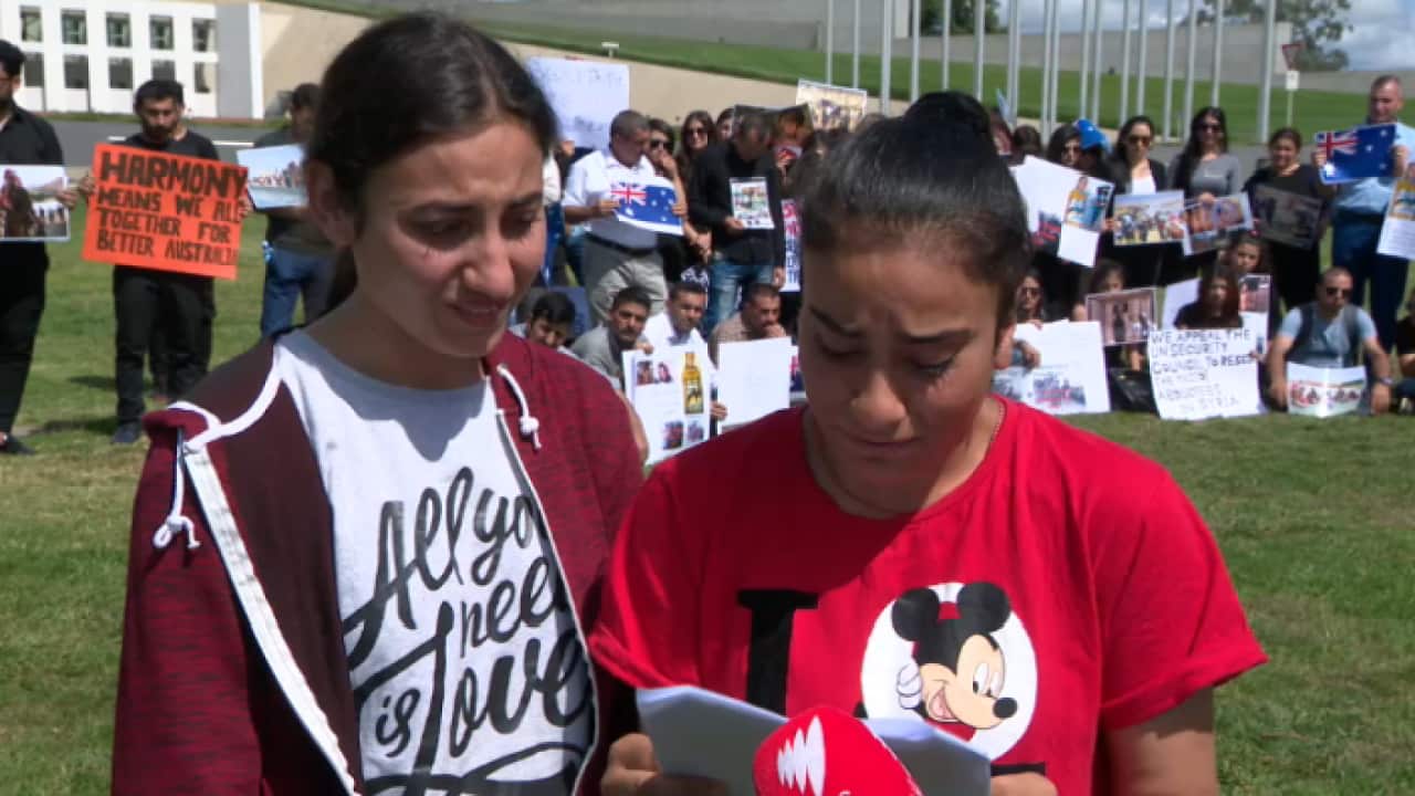 Yazidi teenagers Maryam Sloman and Yvette Hasan speaking outside Australia's Parliament House in Canberra.