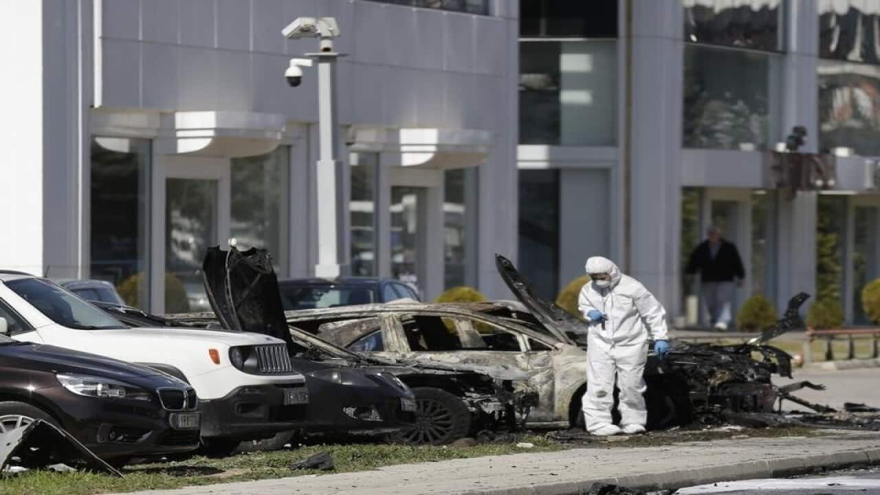 A Greek forensic expert examines the crime scene