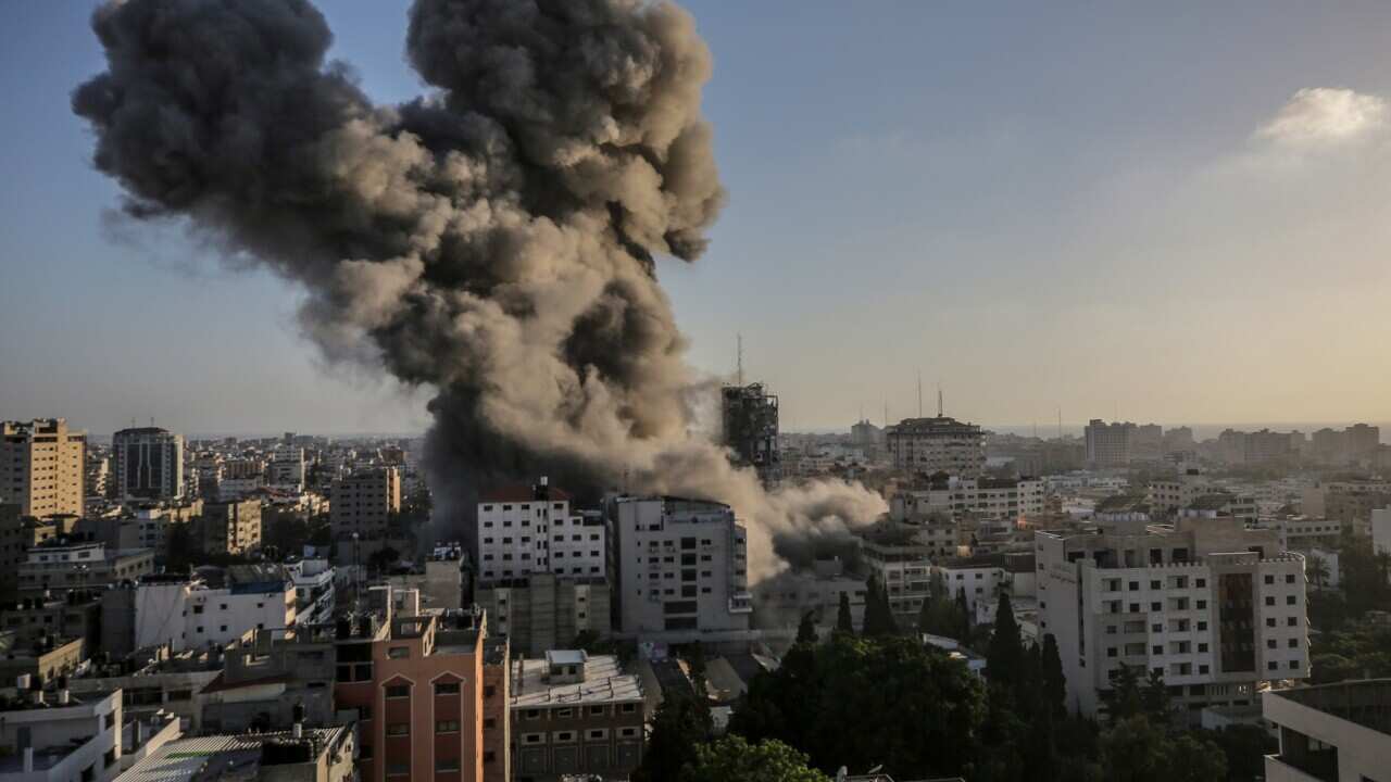 Smoke rises after an Israeli strike Al-Shorouq tower in Gaza City